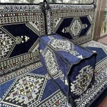 Blue Majlis sofa with intricate white embroidery patterns.