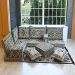 Traditional floor seating with cushions and backrests.